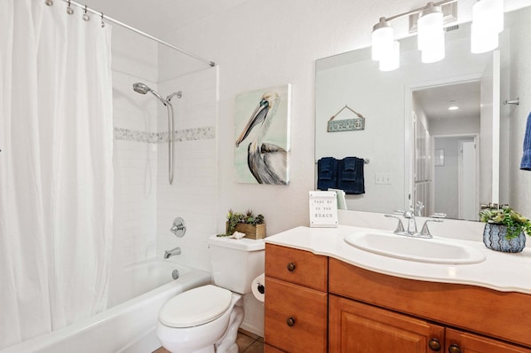 A bathroom with a shower, toilet, sink, and a mirror. - SEAbbatical by the Wharf, 2 BD, 2 BA Duplex, Walk to Beach (Santa Barbara)