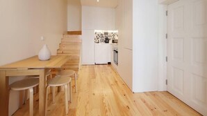 A compact kitchen with white cabinets and a small countertop. - HM - Pinheiro Duplex Apartment (Porto)