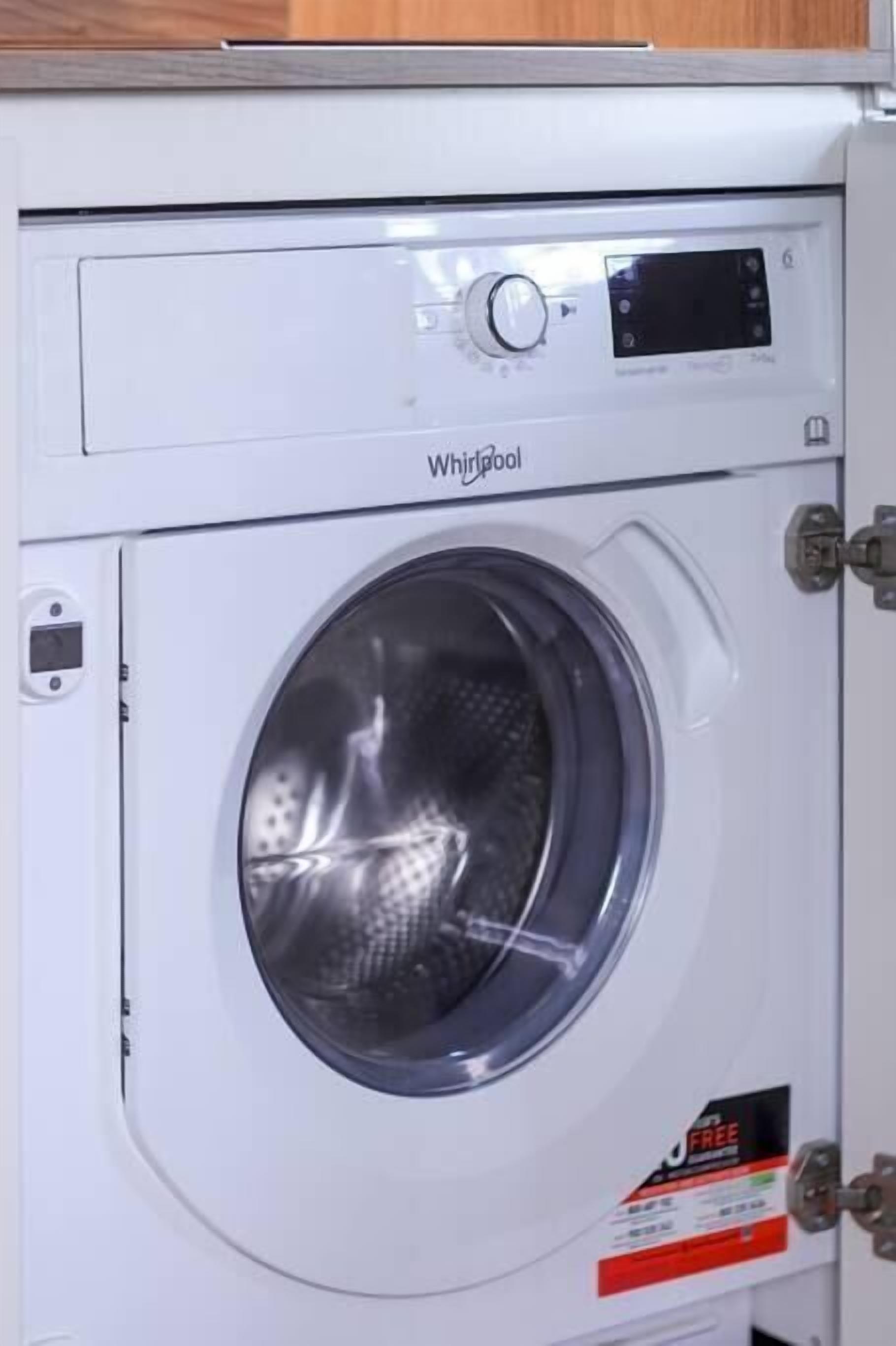 A Whirlpool washing machine with a control panel and a front-loading door.