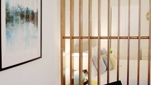 A room with a bed, a bedside table, and a wall-mounted artwork. - HM - Carlos Alberto Apartment 2 (Porto)