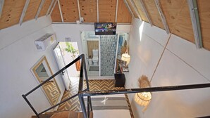 A view from a balcony inside a tent-like structure with a wooden floor, a staircase, and a bathroom visible in the background. - Casa Nomis Cancun (Cancun)