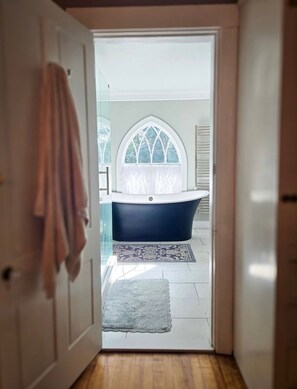 Separate tub and shower, towels, toilet paper