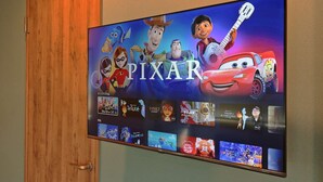 A flat-screen TV mounted on a wall displaying the Pixar logo and characters from various movies. - V.Close to Shinjuku Kabukicho H (Shinjuku-ku)