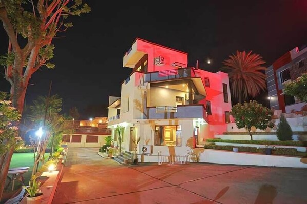 A modern two-story building with a flat roof and a balcony on the upper floor. - Meera Valley Resort (Udaipur)