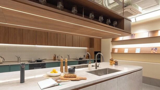 A modern kitchen with a large island, built-in cabinets, and a sleek countertop. - Weave Suites - Sunyu Parkside (Seoul)