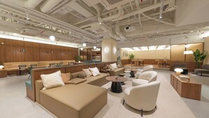 A modern lounge area with sofas, armchairs, and a coffee table. - Weave Suites - Sunyu Parkside (Seoul)