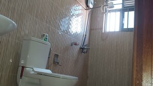 A bathroom with two sinks, a toilet, and a shower. - Remarkable 3-Bed House in Kigali (Kigali)