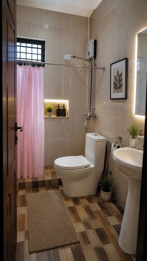 A bathroom with a toilet, bidet, sink, shower, and a pink shower curtain. - Remarkable 3-Bed House in Kigali (Kigali)