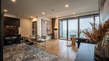 Family Apartment, 4 Bedrooms, Club Lounge Access, City View | Living area | 65-inch Smart TV with cable channels, Netflix, smart speakers