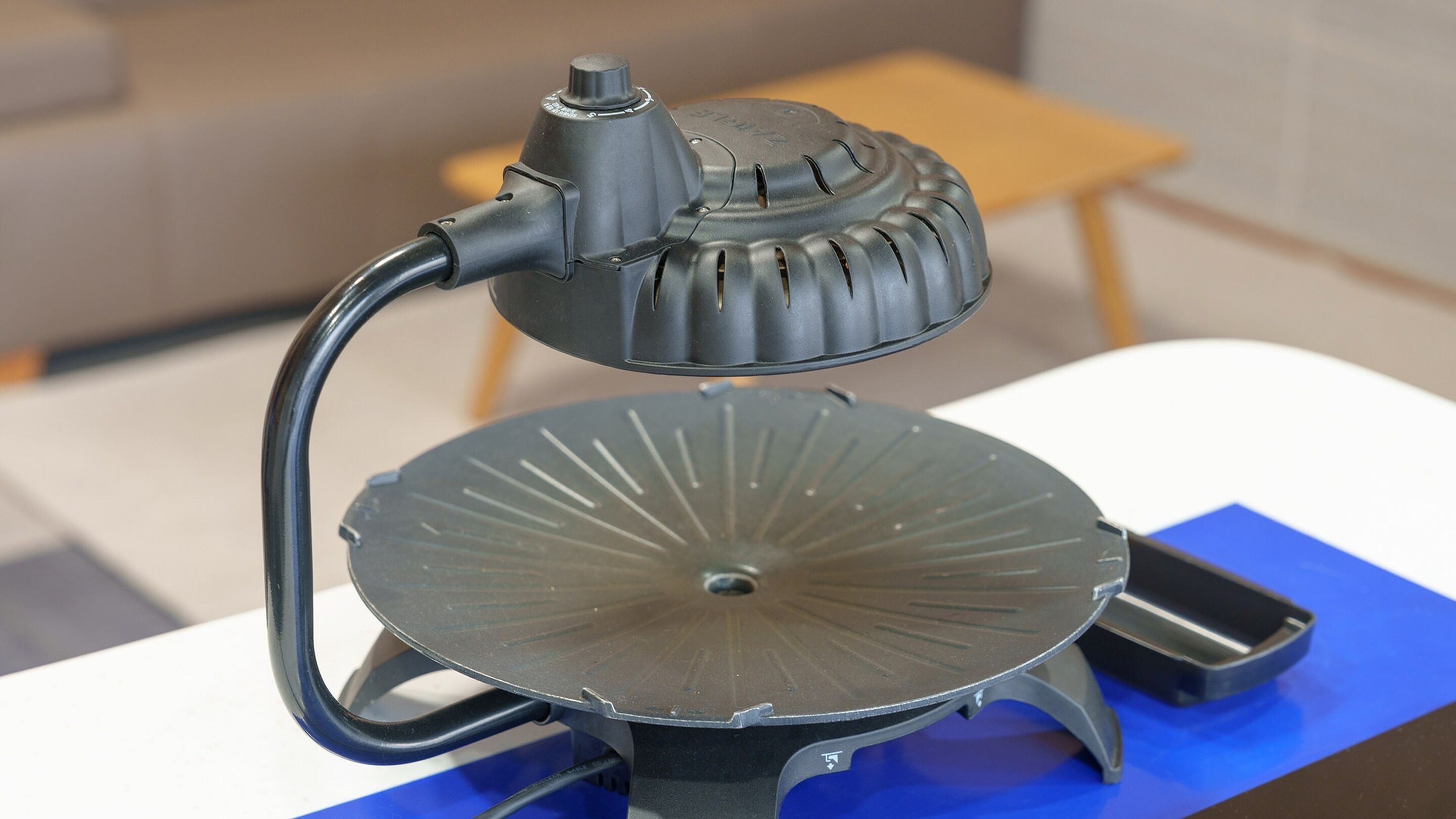 A table with a lamp and a fan.