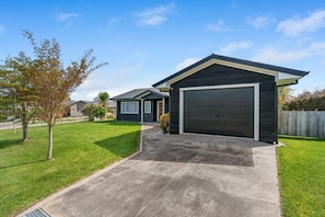 Situated in a well-maintained neighborhood, this two-story house offers a clean, contemporary design with a front porch.