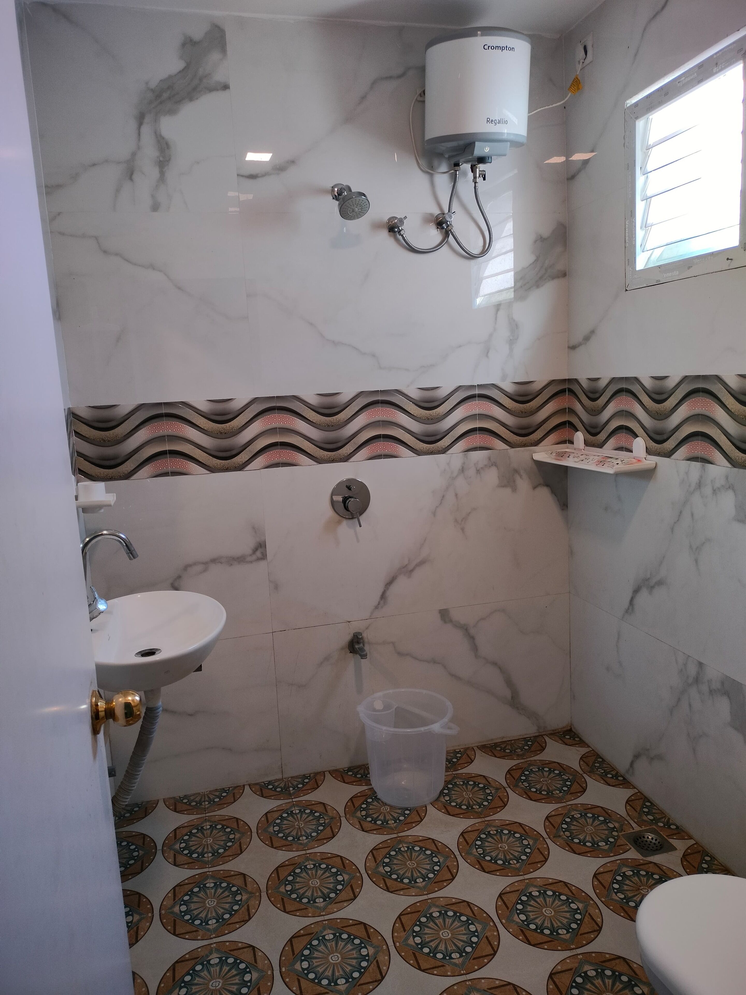 A bathroom with a sink, shower, and toilet.