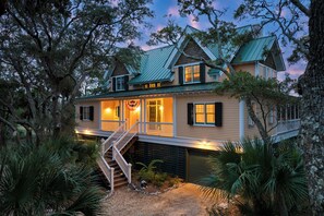 A two-story house with a covered porch, a staircase, and a garage.