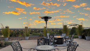 An outdoor patio with a round table and chairs, a solar lamp, and a sign reading "PASO VISTA BELLA". - Paso Vista Bella by AvantStay | Luxe Group Escape w/ Wine Country Views (Paso Robles)