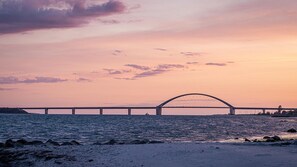 Een brug over water met een zonsondergang.
