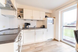 Fridge, stovetop, dishwasher, coffee/tea maker