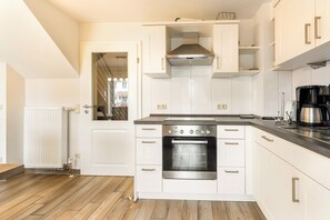 Fridge, stovetop, dishwasher, coffee/tea maker