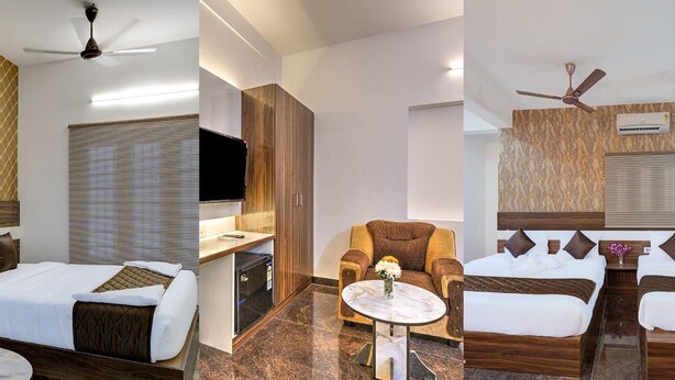 Ein Hotelzimmer mit Bett, Schreibtisch, Stuhl und Deckenventilator.
