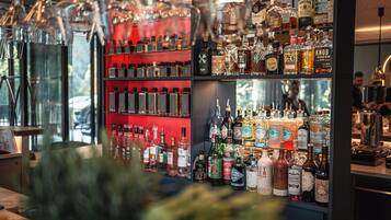 A bar area with shelves of various liquor bottles and glasses.