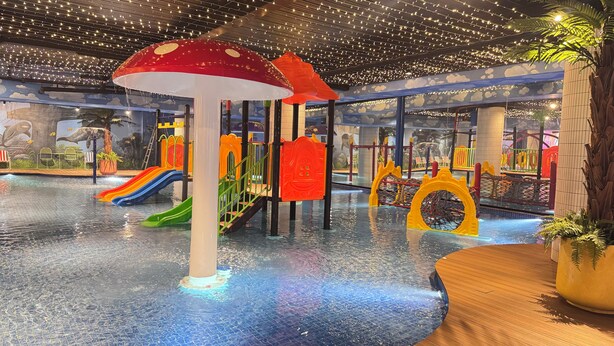 An indoor water play area with slides and climbing structures. - Yellow Bee Resort Cililitan  (Jakarta)