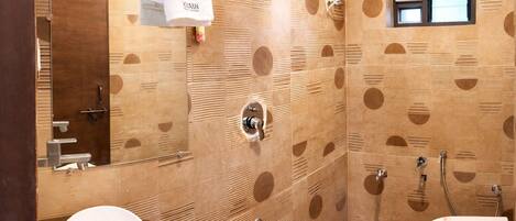 A bathroom with a wooden wall design, a sink, a toilet, and a towel hanging on a rack.