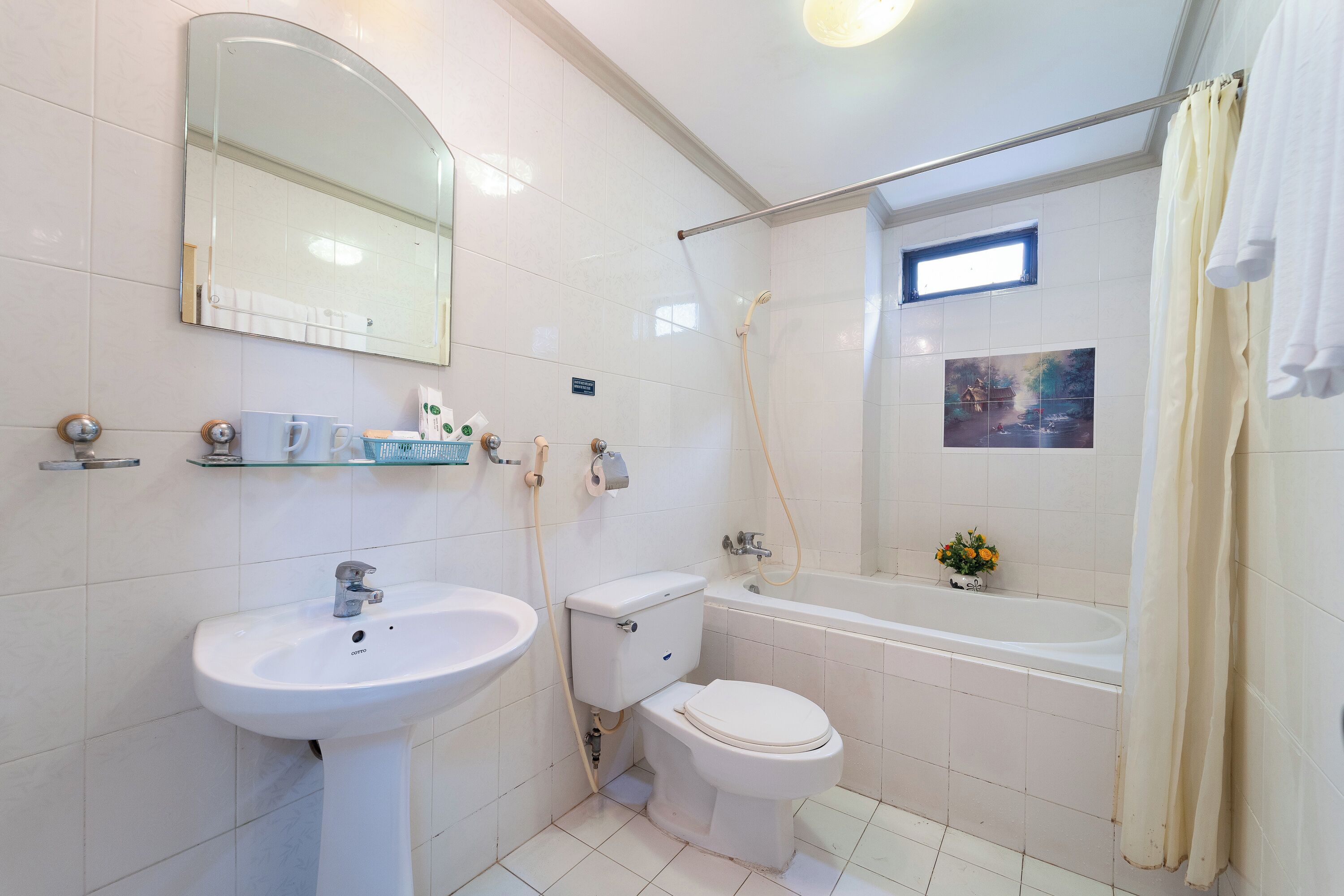 A bathroom with a sink, toilet, and bathtub.