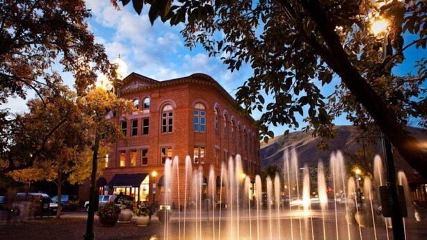 A brick building with arched windows and a fountain in front. - 3 Bedroom Condo at Historic Lift 1A in Downtown Aspen (Aspen)