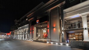 A modern hotel entrance with a prominent 'RED' sign, large columns, and a well-lit facade. - Radisson RED Phuket Patong Beach (Patong)