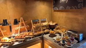 A bakery display with various baked goods and a toaster. - Radisson RED Phuket Patong Beach (Patong)