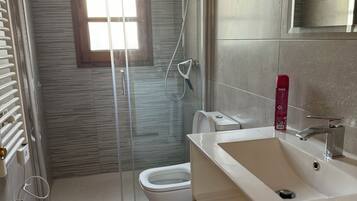 Een douche, een haardroger, een bidet, handdoeken