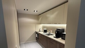 A modern kitchen with recessed lighting, wooden cabinets, and a stainless steel sink. - Stylish Duplex in Tallinn’s Old Town with Fast WiFi  (Tallinn)