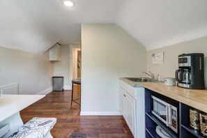 Fridge, microwave, coffee/tea maker, cookware/dishes/utensils