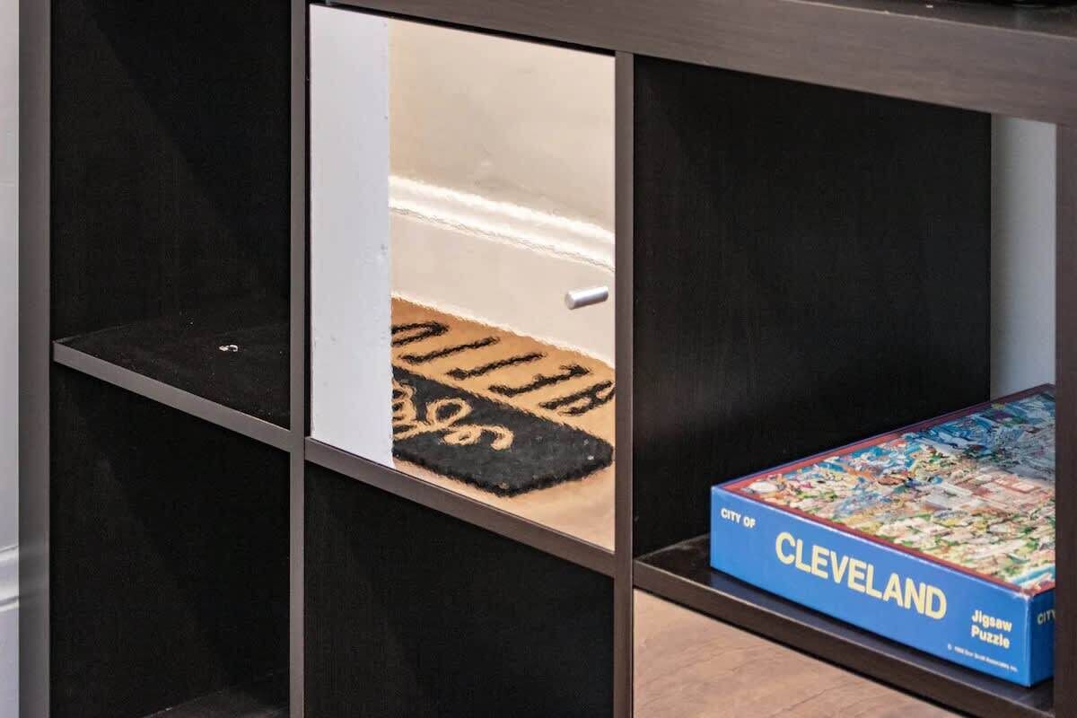 A jigsaw puzzle box labeled "City of Cleveland" on a shelf.
