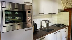 Coffee/tea maker, high chair, cookware/dishes/utensils, dining tables