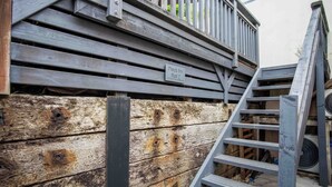 Eine Holzterrasse mit einem Schild, das auf die Wohnung Nummer 2 hinweist.