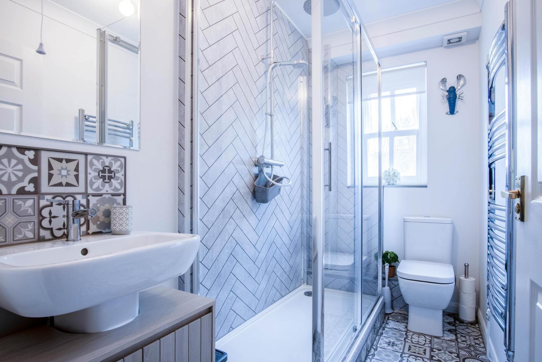A modern bathroom with a large sink, shower, and toilet.