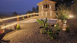 A stone building with a tiled roof, surrounded by gravel and potted plants. - The Cozy Acorn Resort (Nainital)