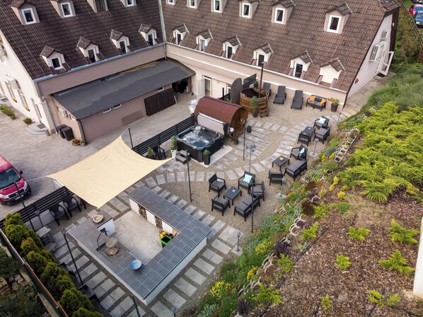 An aerial view of a courtyard with outdoor seating, a hot tub, and a garden area. - Árnyas Panzió Gödöllő (Gödöllő)