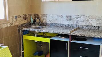 Een koelkast, een oven, een kookplaat, een koffiezetapparaat/waterkoker