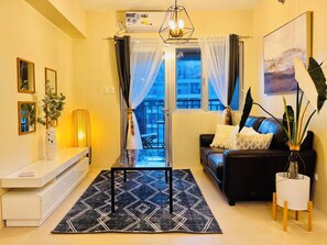 Comfort Condo, 2 Bedrooms, Balcony, Poolside | Living room | 45-inch Smart TV with cable channels - Avida Towers Atria (Iloilo)