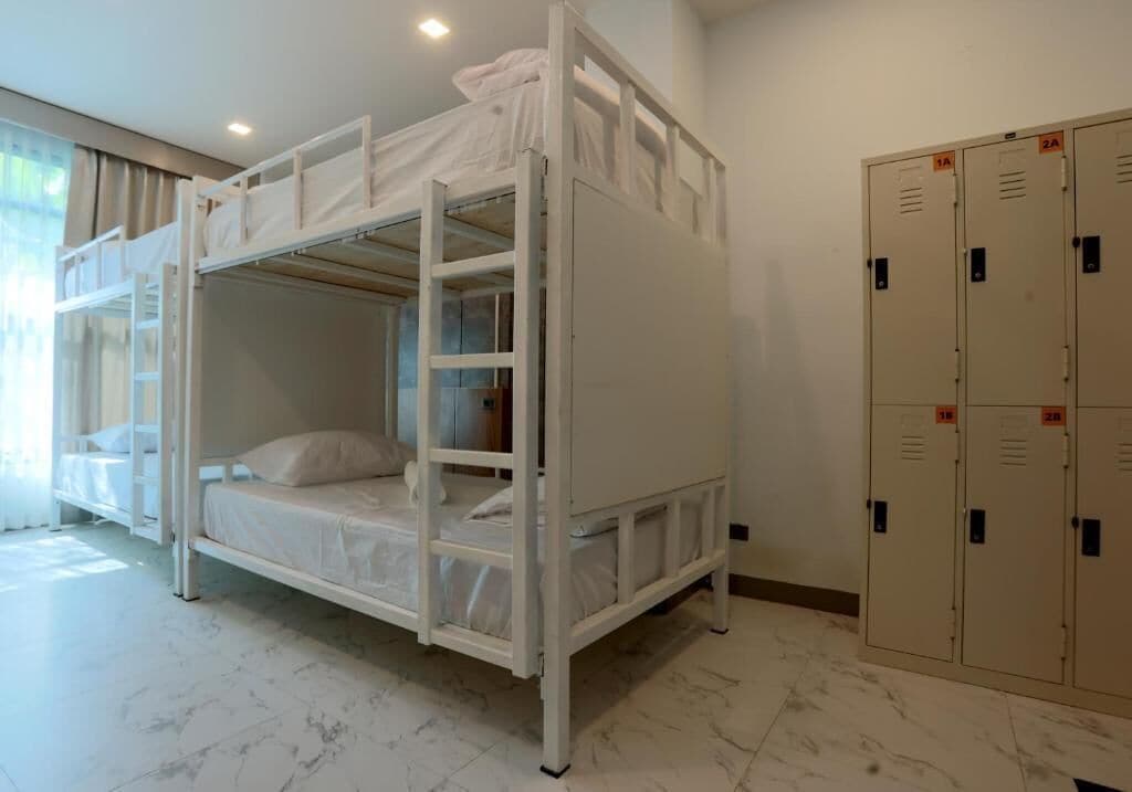 A bunk bed room with a wardrobe and lockers.
