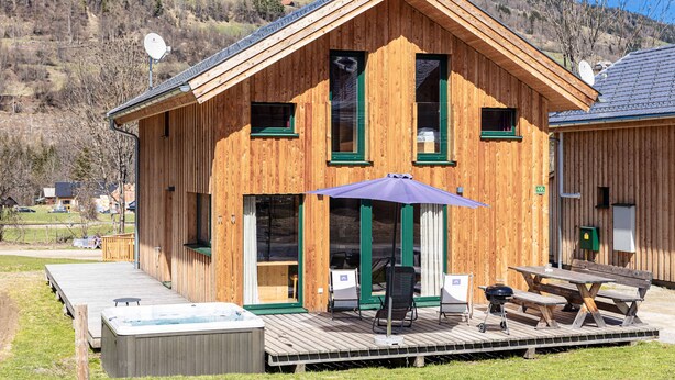 A wooden cabin with a deck, outdoor seating, and a hot tub. - Chalet # 49b with 4 Bedrooms, IR sauna & whirlpool (St. Georgen am Kreischberg)