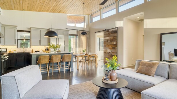 A modern open-plan living space with a kitchen, dining area, and seating area. - Sundrenched by Avantstay Pool, Mins to Old Town (Scottsdale)