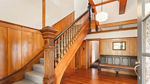 A wooden staircase with a bench at the bottom. - Modernized country house set in beautiful gardens with swimming pool.  
 (Rangitumau)