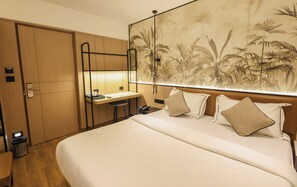 Relax in this inviting space with a large bed, desk, and wardrobe, perfect for unwinding and staying productive.