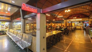 A restaurant with a neon sign, a juice center, and a food inn. - Hotel Western (Mumbai)