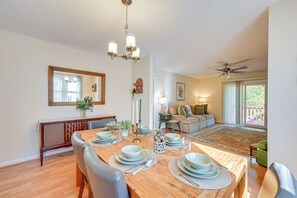 A dining area with a wooden table set for four, surrounded by chairs. - Home w/ Large Yard: 6 Mi to Dtwn Winston-salem! (Winston-Salem)