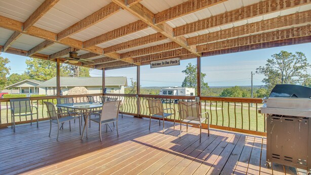 A covered outdoor patio with a grill, tables, and chairs. - Lake-view Getaway w/ Grill in Mountain Home! (Mountain Home)