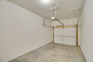 A garage with a concrete floor, white walls, and a closed garage door. - 1 Mi to Dtwn Salida: Townhome w/ Fenced Yard! (Salida)