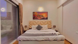 A modern bedroom with a large bed, a ceiling fan, and a painting on the wall. - Scarlet By Stellar Stays (Mawal)